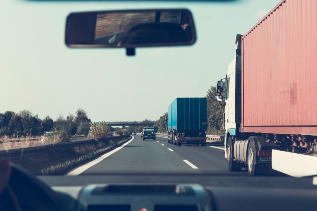 View through rearview mirror of trucks on a German highway, driving towards Bamberg.