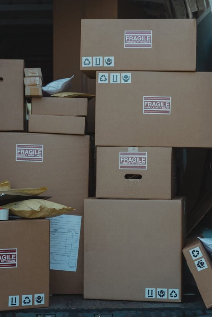 Vertical stack of cardboard boxes labeled 'fragile' for shipping and storage.